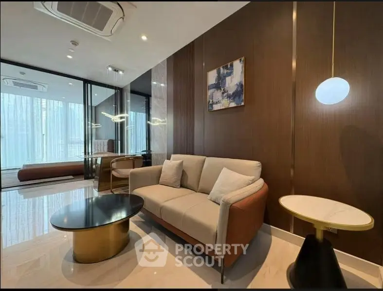 Luxurious modern living room with elegant furniture and stylish decor, featuring a cozy sofa and chic coffee table.