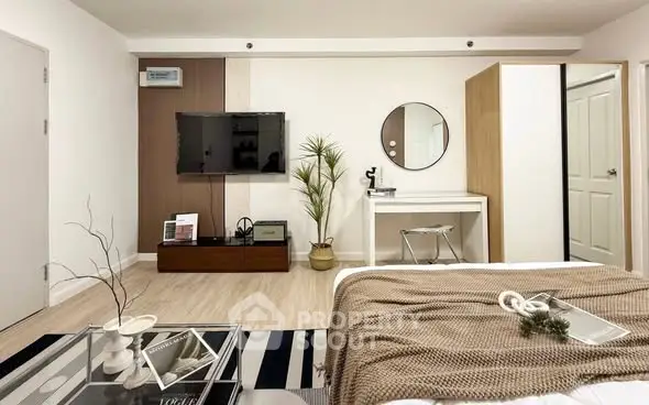 Modern bedroom with stylish decor and wall-mounted TV in a cozy apartment.
