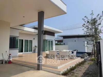 Modern patio with outdoor dining set and pool view in contemporary home