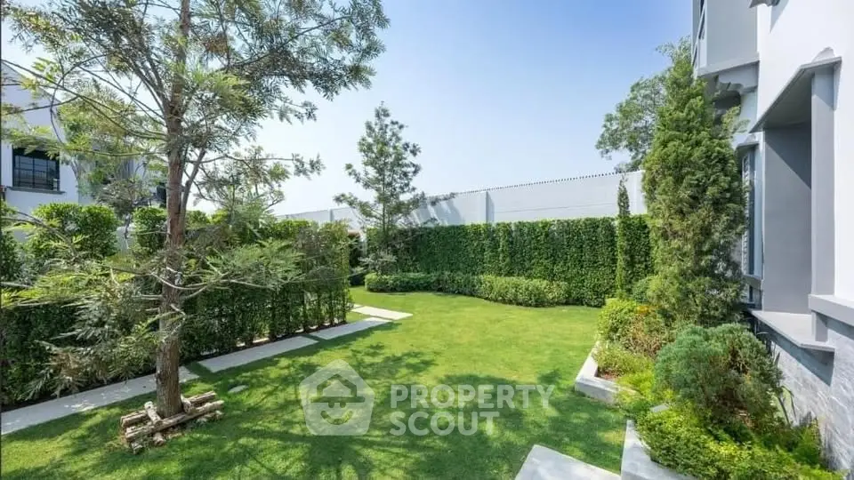 Beautifully landscaped garden with lush greenery and modern architecture, perfect for relaxation and outdoor activities.