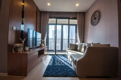 Modern living room with sleek decor and city view balcony.