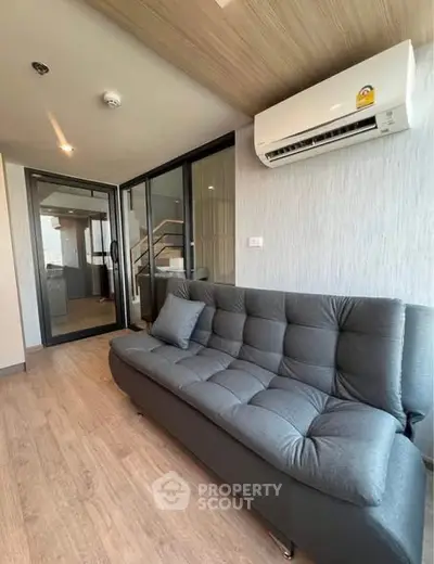 Modern living room with sleek sofa and air conditioning in stylish apartment