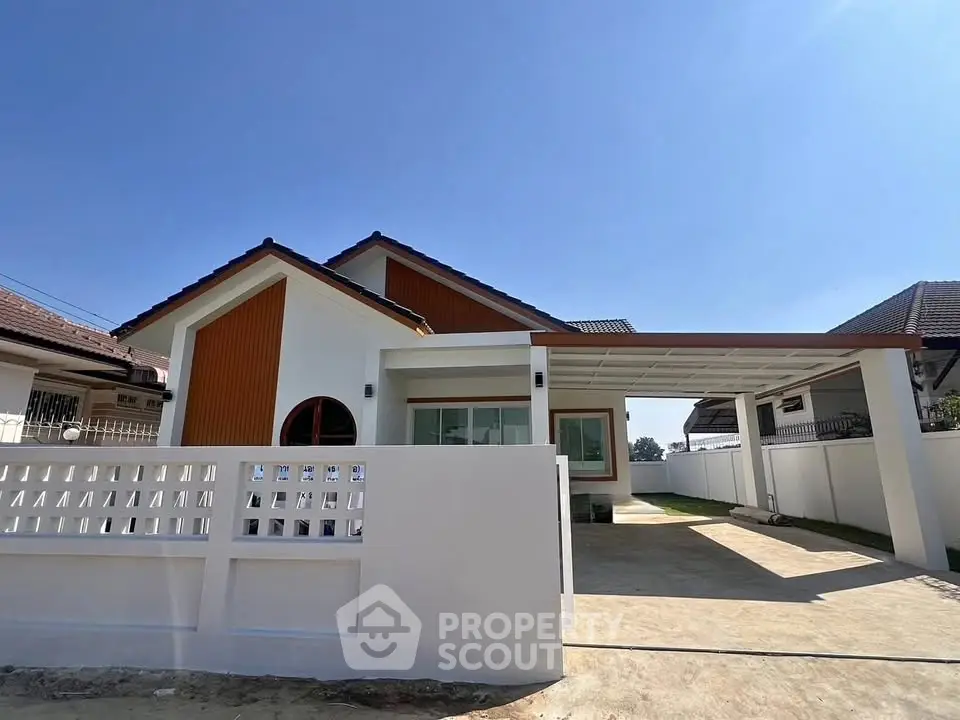 Charming single-story home with modern design and spacious driveway in a sunny neighborhood.