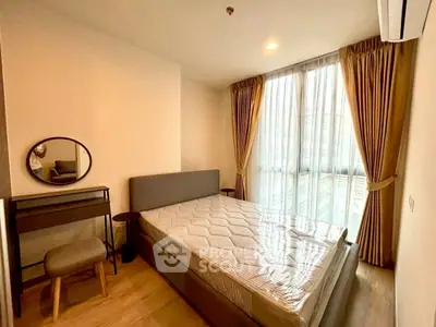 Cozy bedroom with modern furnishings and large window for natural light