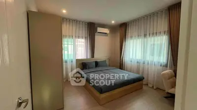 Cozy bedroom with modern decor and ample natural light