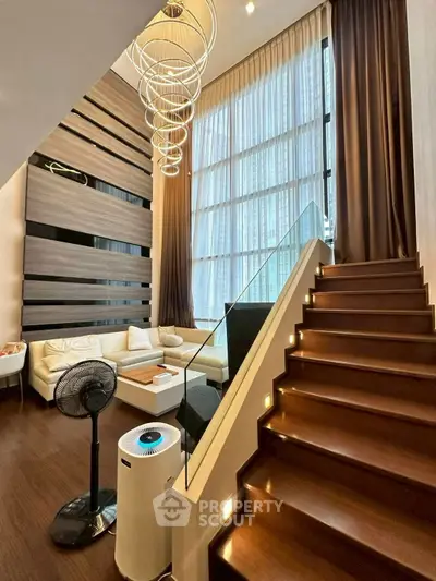 Luxurious modern living room with high ceilings and elegant staircase