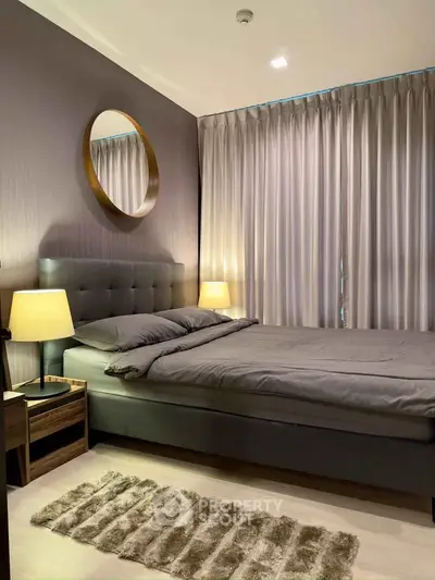 Elegant bedroom with modern decor, featuring a plush bed, stylish mirror, and ambient lighting.