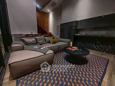 Luxurious modern living room with stylish furniture and open kitchen layout.