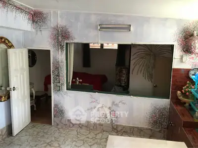 Charming interior with unique wall art and cozy furnishings, perfect for a creative living space.