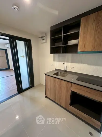 Modern kitchen with sleek cabinetry and open layout in a stylish apartment.