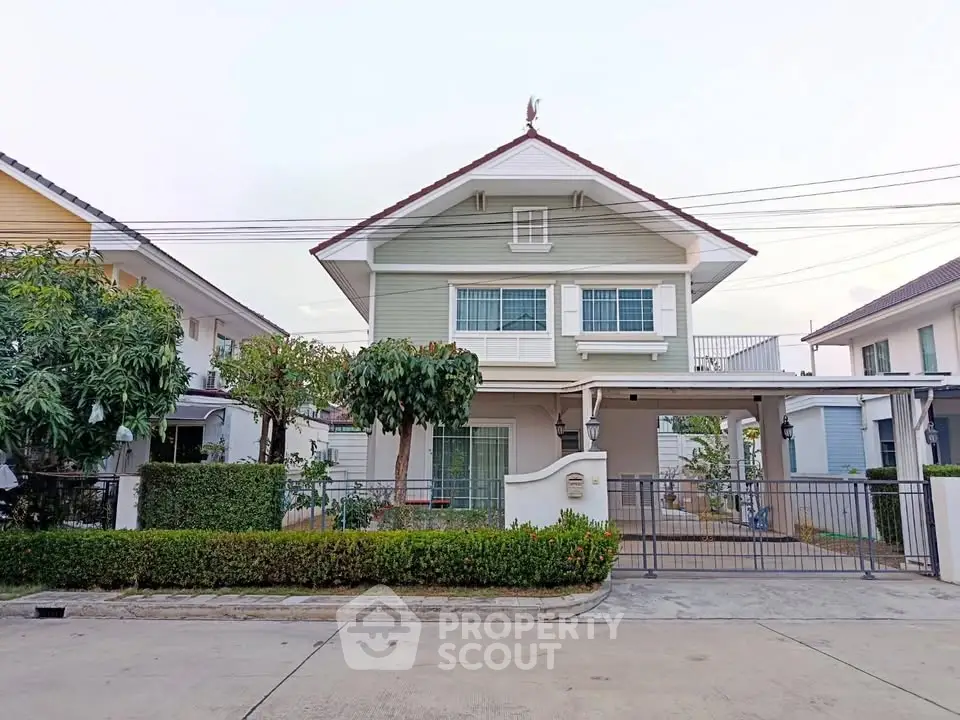 Charming two-story house with lush garden and spacious driveway in a serene neighborhood.