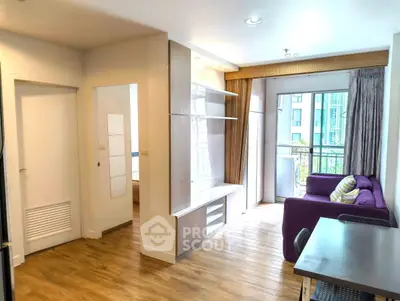 Modern living room with wooden flooring, purple sofa, and balcony view in a stylish apartment.