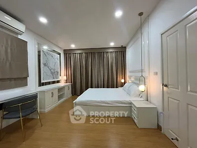 Spacious modern bedroom with elegant decor and ambient lighting