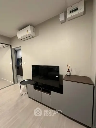 Modern living room with sleek TV stand and air conditioning unit