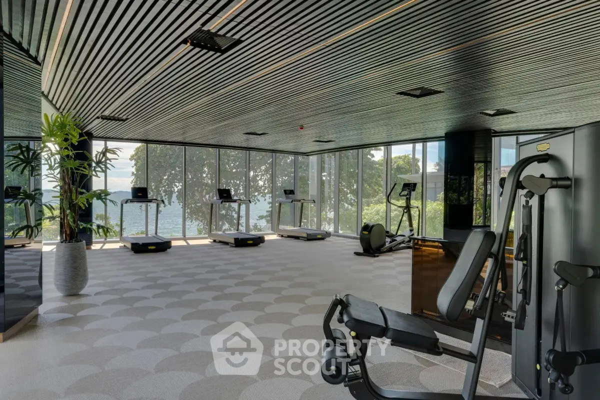 Luxurious gym with modern equipment and stunning waterfront views.