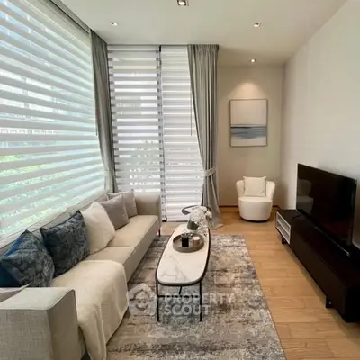 Modern living room with stylish decor and large windows