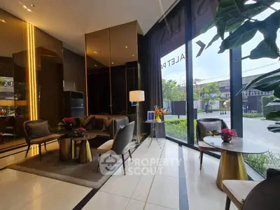 Luxurious modern lobby with elegant seating and floor-to-ceiling windows offering garden views.
