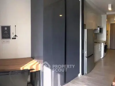 Modern kitchen with sleek appliances and stylish workspace in contemporary apartment.
