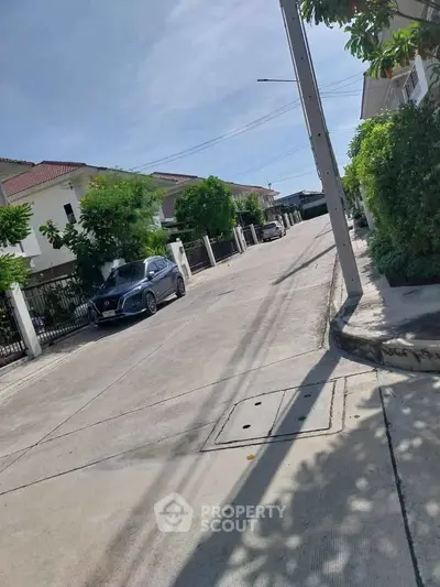 Charming suburban street with modern homes and lush greenery, ideal for family living.