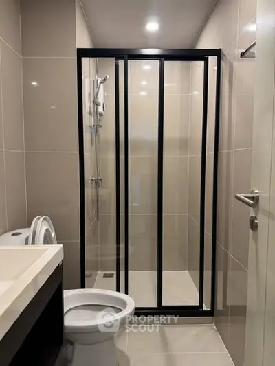 Modern bathroom with sleek shower enclosure and contemporary fixtures.