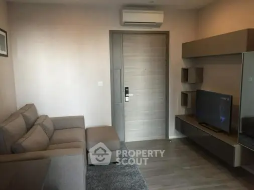 Modern living room with sleek furniture and wall-mounted TV