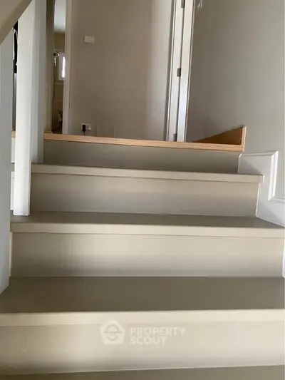 Modern interior staircase with sleek design and neutral tones