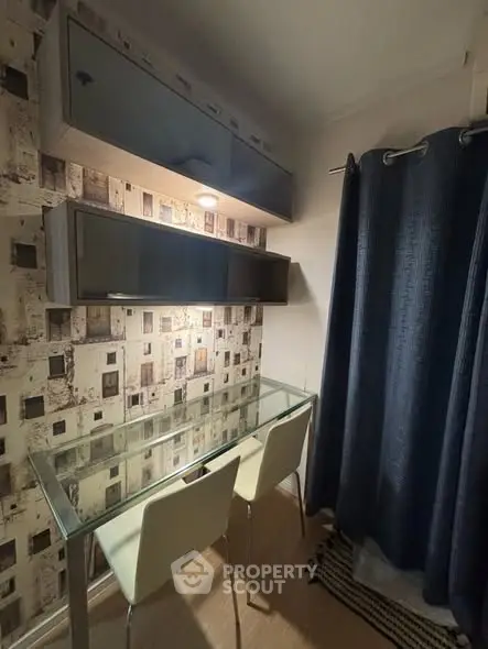 Chic study nook with glass desk and modern shelving in cozy apartment