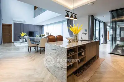 Luxurious open-plan living room with modern kitchen island and elegant decor
