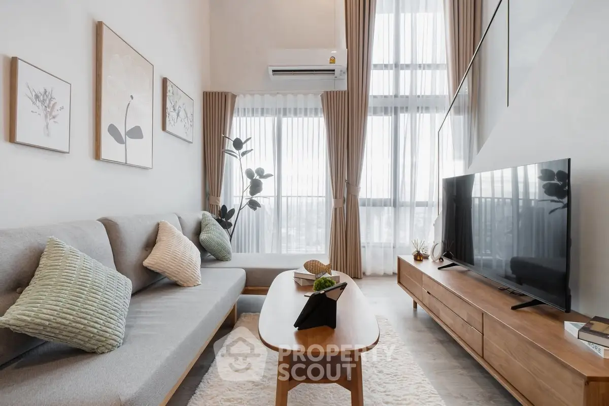 Stylish modern living room with high ceilings, large windows, and elegant decor.