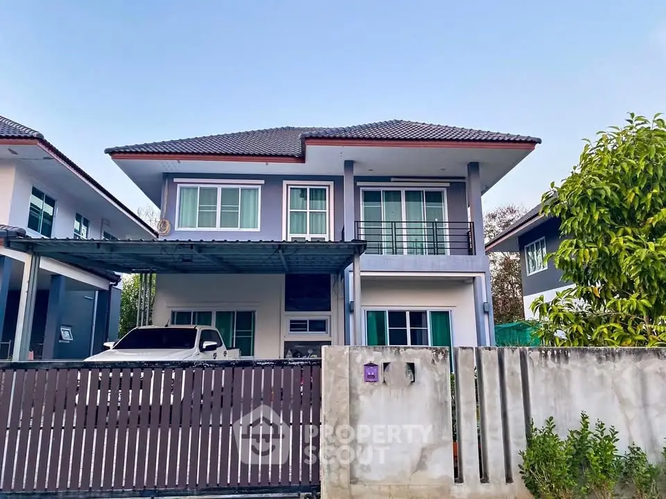 Charming two-story house with gated driveway and modern design