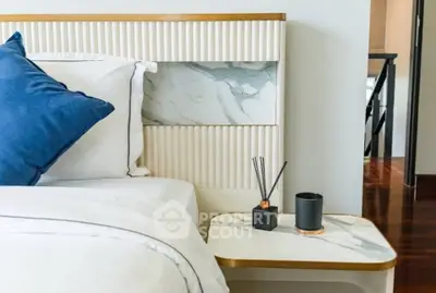 Luxurious bedroom corner with elegant marble nightstand and plush bedding