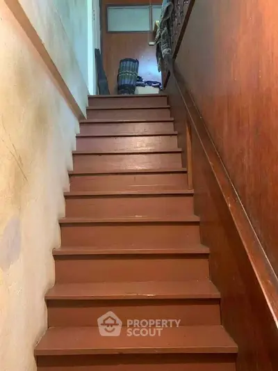 Charming wooden staircase leading to upper floor in cozy home
