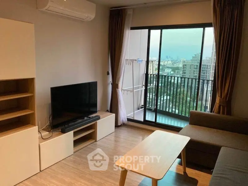 Modern living room with balcony view in high-rise apartment