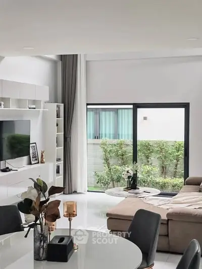 Spacious modern living room with large windows and stylish decor
