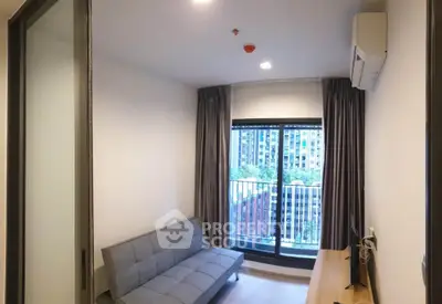 Modern living room with balcony view in urban apartment, featuring sleek furniture and natural light.