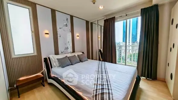 Modern bedroom with stylish decor and city view, featuring a sleek bed and ample natural light.
