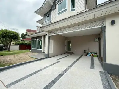 Spacious modern home with large driveway and elegant exterior design