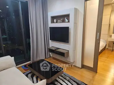 Modern living room with sleek TV unit and cozy decor in a stylish apartment