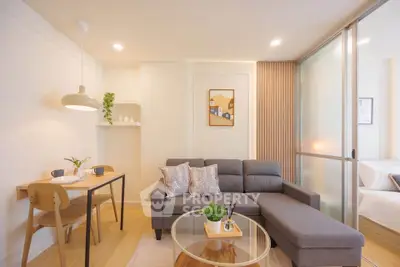 Modern living room with stylish decor and cozy seating in a bright apartment.