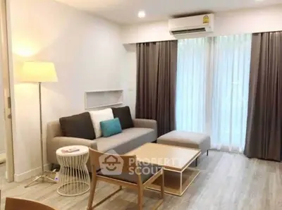 Modern living room with stylish furniture and large window for natural light.