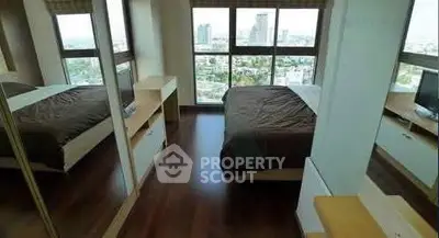 Spacious bedroom with city view and modern furnishings