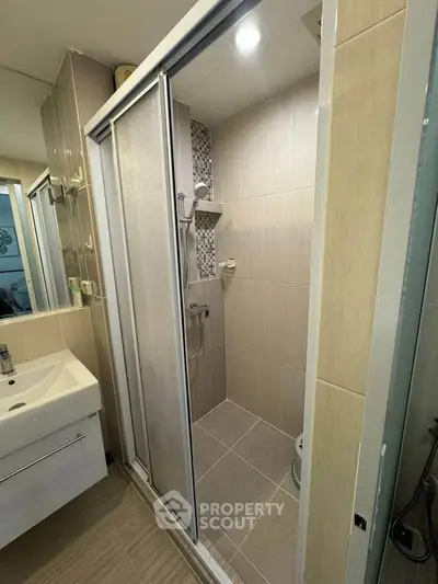 Modern bathroom with sliding shower doors and sleek vanity unit