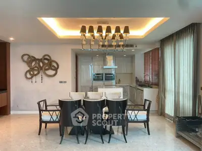 Elegant dining area with modern chandelier and open kitchen layout in luxury apartment.