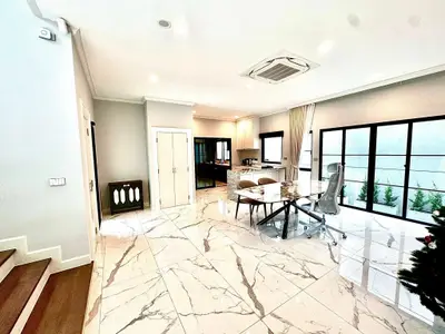 Luxurious open-plan living area with marble flooring and modern furnishings