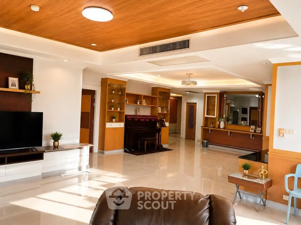 Spacious living room with modern decor and elegant wooden accents