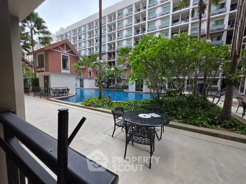 Luxurious poolside view with modern apartment complex and lush greenery, perfect for relaxation and leisure.