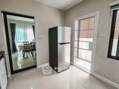 Modern kitchen with stainless steel fridge and dining area view