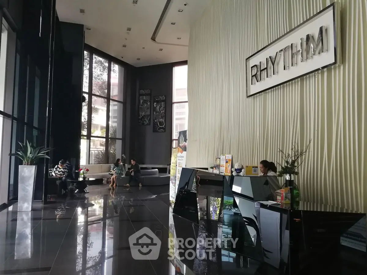 Luxurious modern building lobby with sleek design and comfortable seating area.