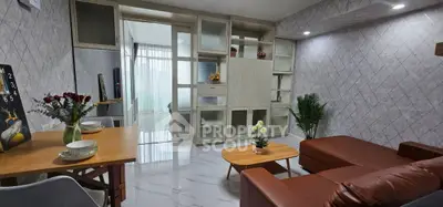 Modern living room with stylish furniture and open layout, featuring a cozy seating area and elegant decor.