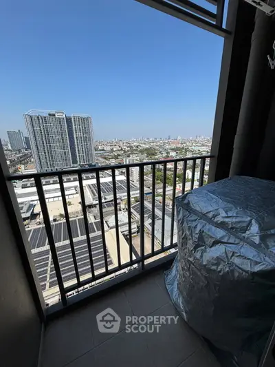 Stunning high-rise balcony view overlooking cityscape with clear blue skies, perfect for urban living.